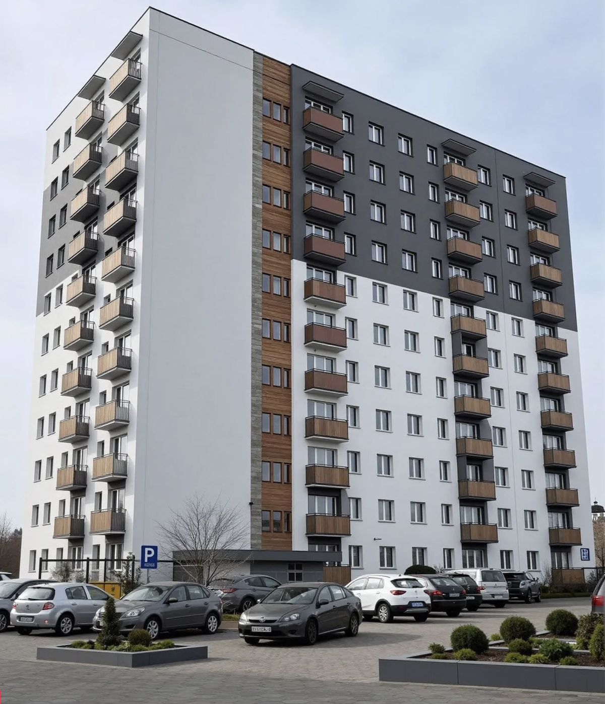 Blok mieszkalny nr 27 po renowacji elewacji — nowoczesna biało-grafitowa elewacja z panelami drewnianymi